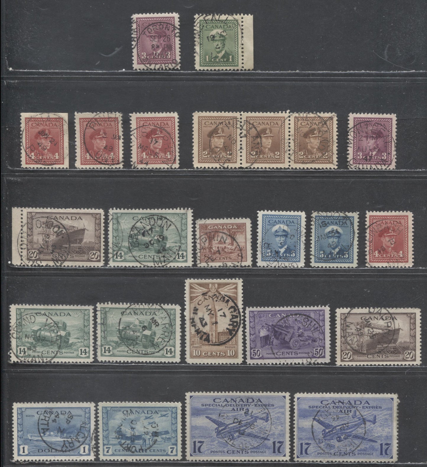 Lot 404 Canada #249-250, 252, 254-257, 259-262, C8, CE1-CE2 1c-5c, 10c, 14c-$1, 7c, 16c-17c Green - Steel Blue King George VI & Various Scenes, 1942-1949 War Effort Issue, 21 VF Used Singles, With SON Dated CDS Town Cancels & In-Period