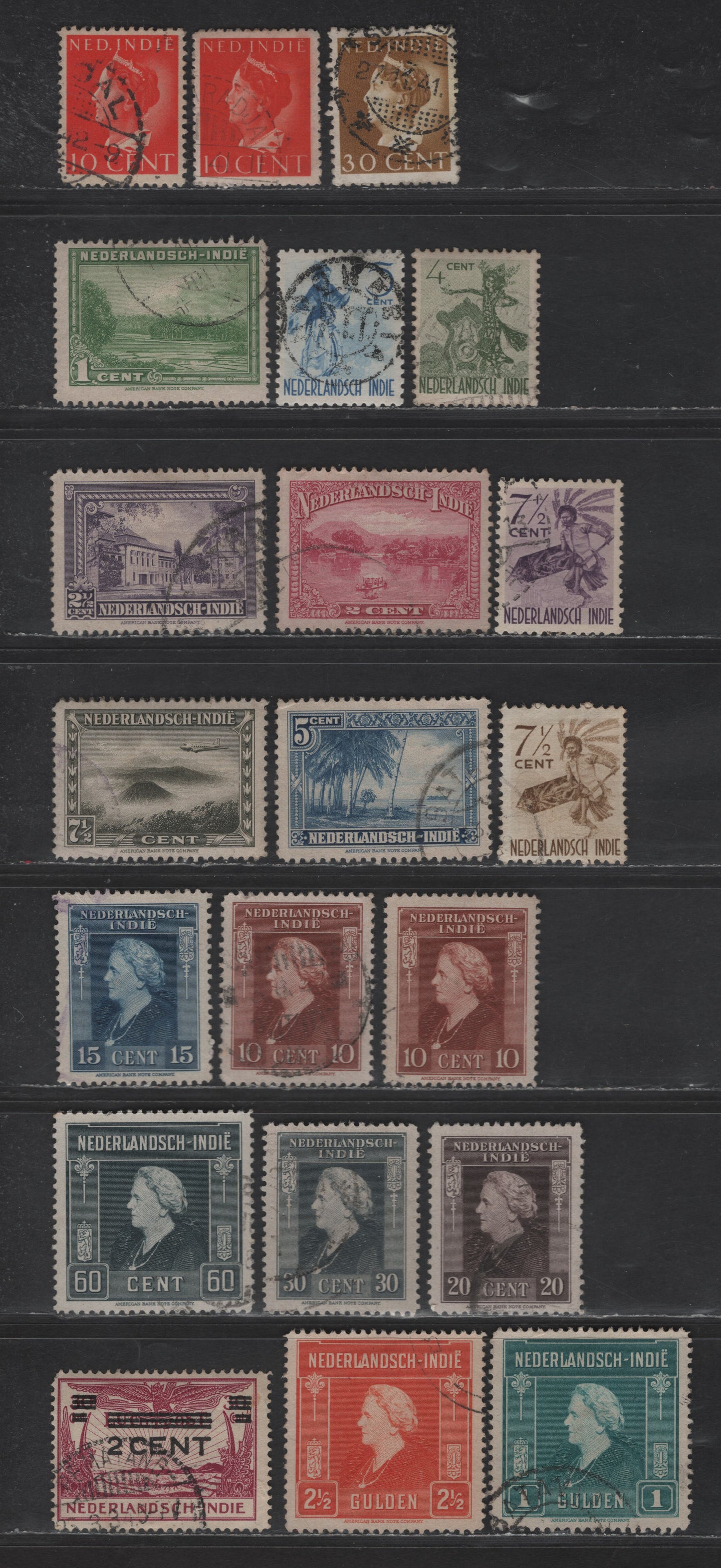 Lot 239 Netherlands Indies SC#234-a, 239, 230-242, 293, 250-262, 191 10c - 2.5g Red Orange Queen Wilhelmina - Scenes, 1941-1946 Queen Wilhelmina - Pictorial Issues, 21 Fine/Very Fine Used Singles