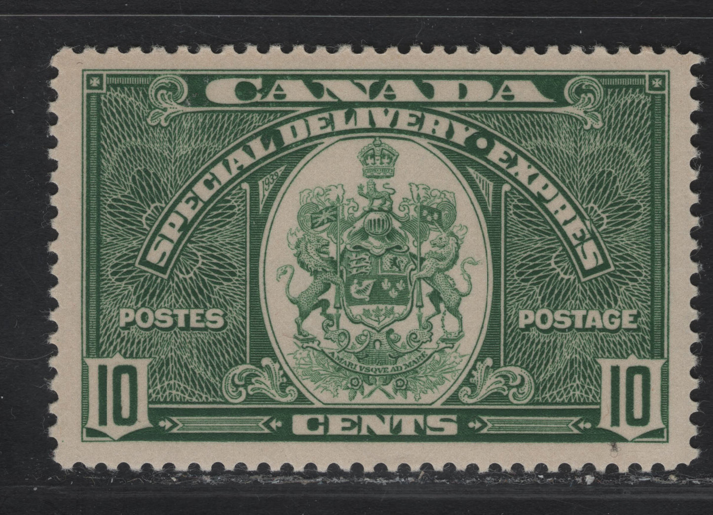 Lot 340 Canada #E7 10c Bluish Green Emblem, 1939 Special Delivery Issue, A VFNH Single, Perf 12x11.95, Paper/Gum CBN-JJ, Gum is NH but There Is Some Ink Offset On The Gum.