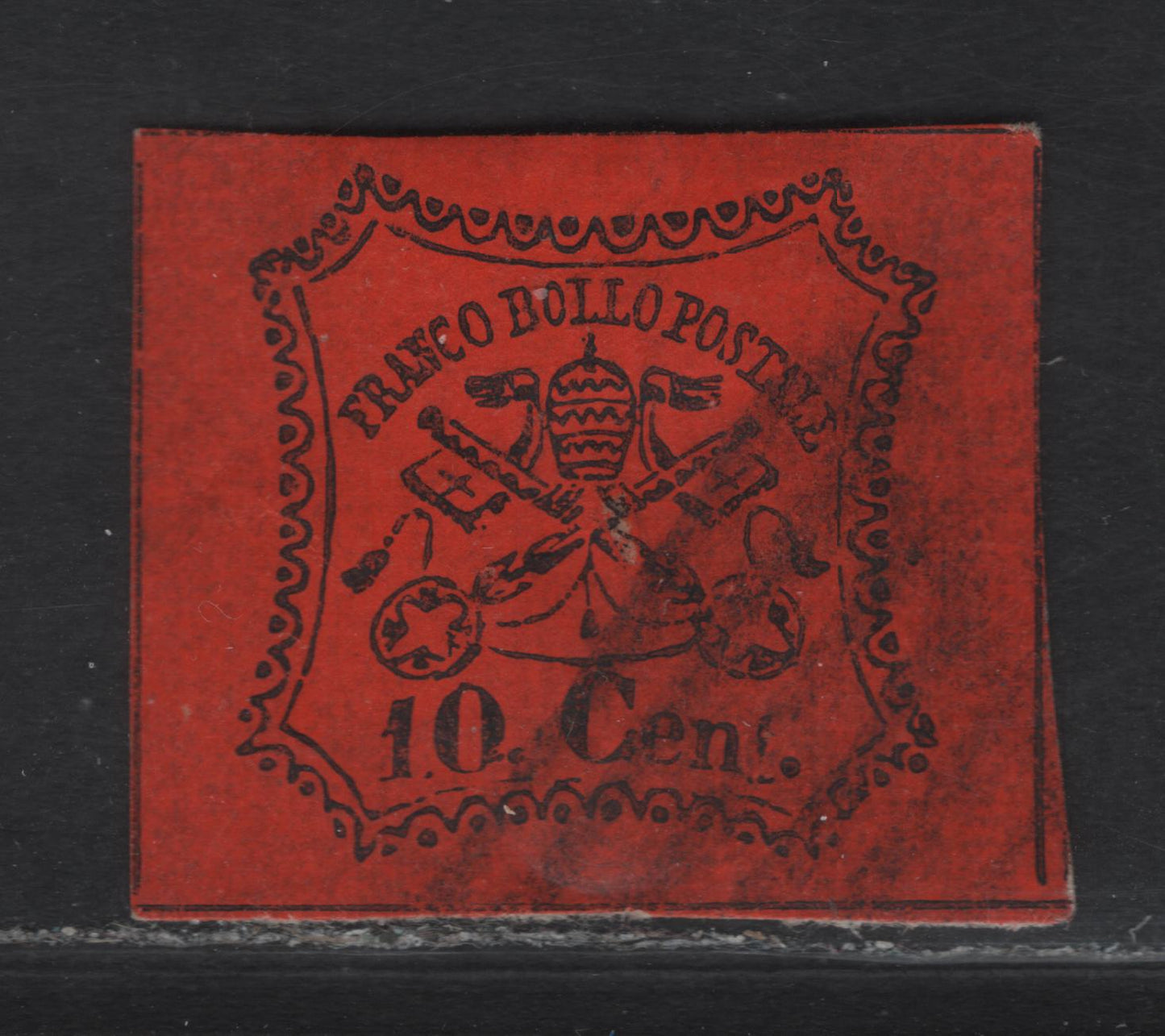 Lot 32 Roman States SC#15 10c Black on Vermillion Papal Arms, 1867 Arms Issue, A Very Fine Used Single, Glazed Paper, Traces of Dividing Lines Visible On All Sides, Clear Evidence That The Horiz Lines Are Continuous.