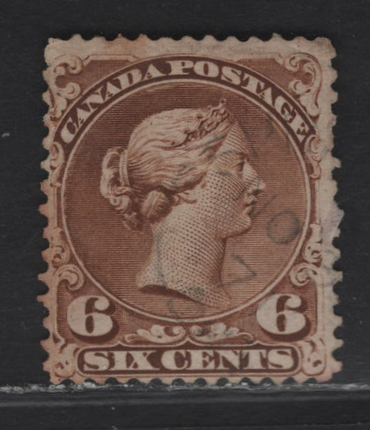 Lot 27 (C) Canada #27a 6c Yellow Brown Queen Victoria, 1868-1876 Large Queen Issue, A Very Good Used Single, Paper FO-D (Silky Smooth Opaque Wove), Perf 12.1x12, Plate 1 Example With Guide Dot Below The LL Scroll.