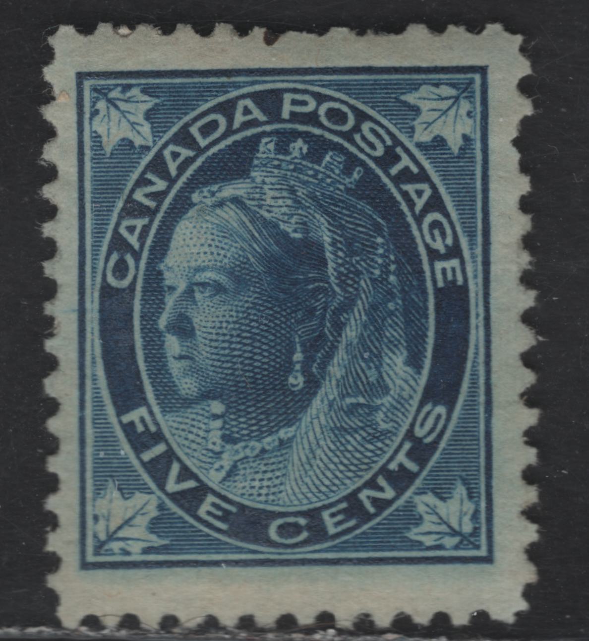 Lot 108 (C)  Canada #70 5c Dark Blue Queen Victoria, 1897-1898 Maple Leaf Issue, A VGOG Single, Paper ABN-FF, Perf 12, Pulled Perfs, Gum Is Full But is Largely Covered By Album Page Adhesions.