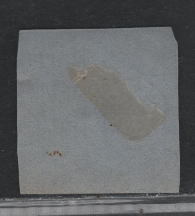 Lot 375 New Brunswick (C) #1 3d Pale Red , 1851 Pence Issue, An Ungraded Used Single, Severly Faulty Used Example Which Has Been Glued To Blue Paper To Hide The Faults, Which Are Mostly Confined to The Upper Right Corner