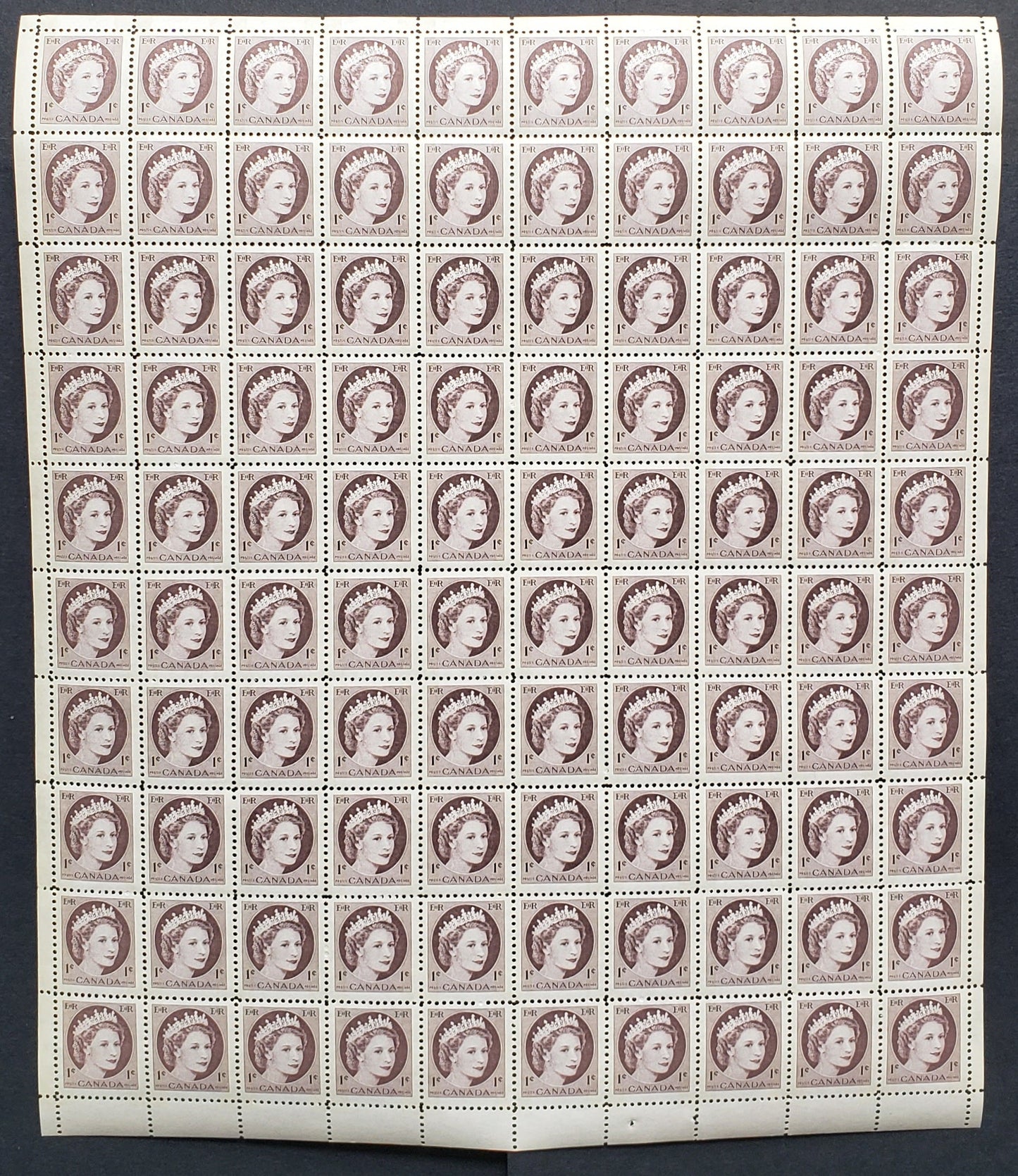 Lot 216 Canada #337p 1c Violet Brown, 1954 Queen Elizabeth 2 - Wilding Portrait Issue, A VFNH Winnipeg Tagged Full Lower Center Pane Of 100 On NF Smooth Paper That Is Lightly Vertically Ribbed On Back. Light Tagging That Glows Bluish. Unfolded