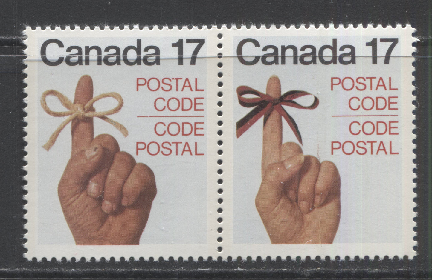 Lot 400 Canada #816avar 17c Multicoloured Male and Female Finger and Ribbon, 1979 Postal Code Issue, A VFNH Se-Tenant Pair  On DF/DF-Fl Paper, Smudge Above Knuckle